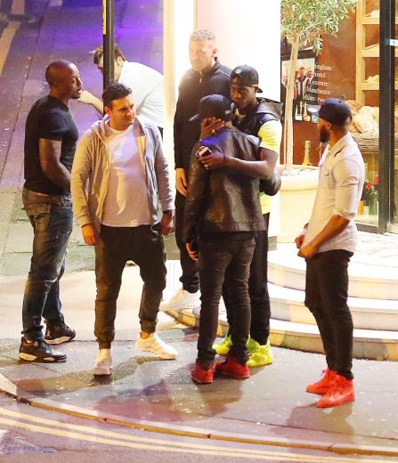 29.8.16...... Liverpool flop Mario Balotelli (wearing lime green shoes) threw a dinner for his boys in the private dining room at San Carlo Italain Restaurant in Manchester city centre on Monday night and it looked like he was saying goodbye to them. Balotelli and his boys got a homeless man begging outside the restaurant to photograph them on their phones.