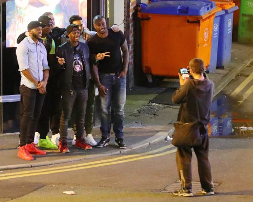 29.8.16...... Liverpool flop Mario Balotelli (wearing lime green shoes) threw a dinner for his boys in the private dining room at San Carlo Italain Restaurant in Manchester city centre on Monday night and it looked like he was saying goodbye to them. Balotelli and his boys got a homeless man begging outside the restaurant to photograph them on their phones.